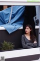 A woman sitting on top of a white and black truck.