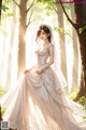 A woman in a wedding dress standing in the woods.