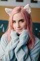 A woman with pink hair wearing a cat ears headband.