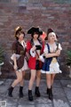 A group of three women dressed in pirate costumes posing for a picture.